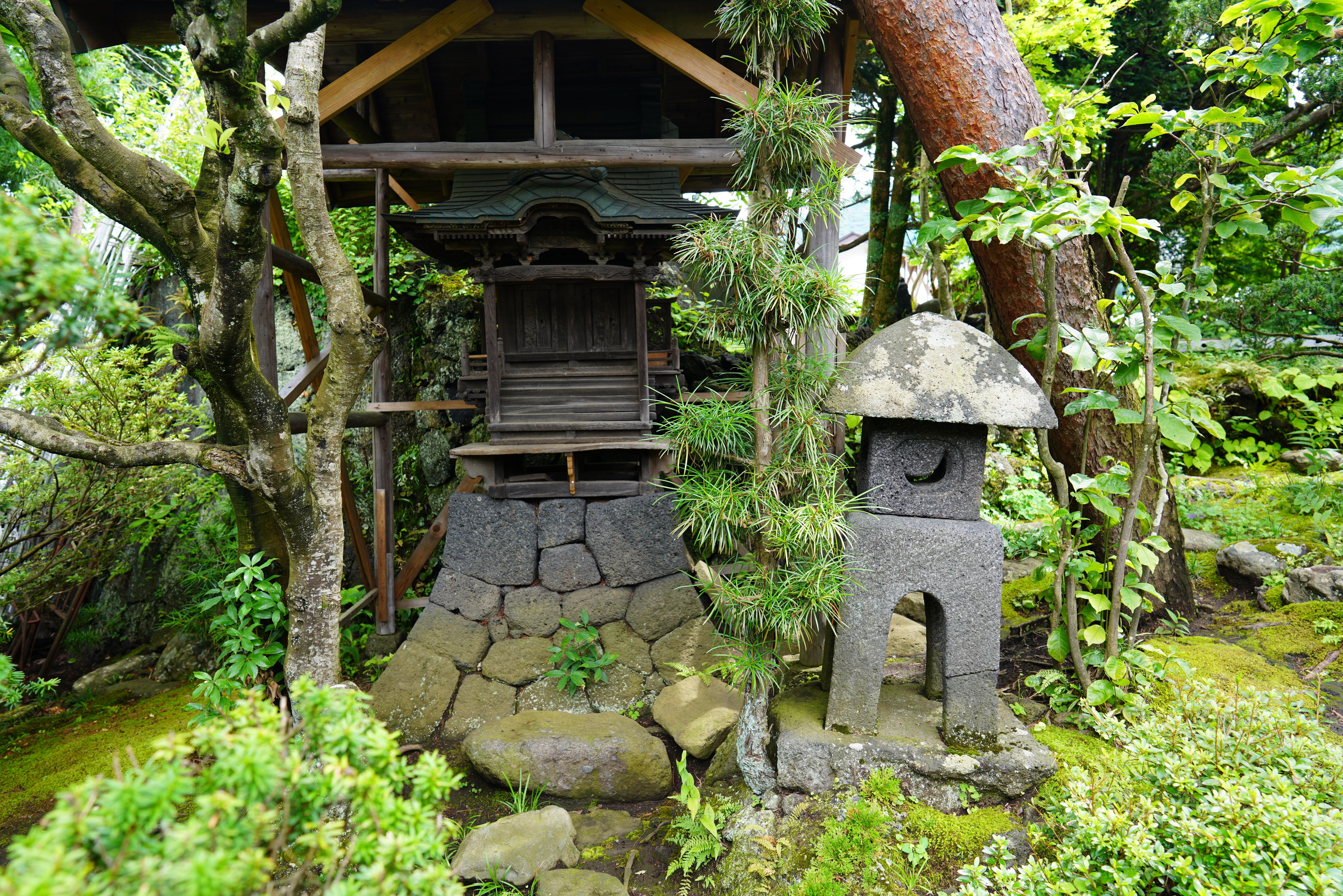 The miniature shrine, whose base is made of volcanic stones, is part of Ide Jyozoten's 300-year-old garden.